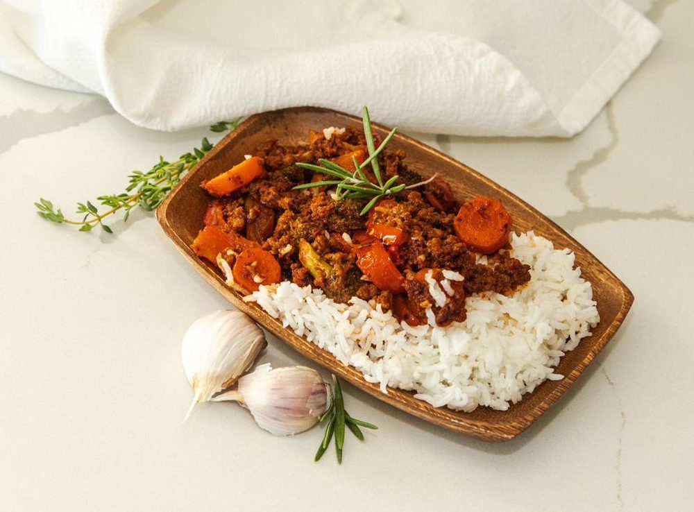 A beef and vegetable stew served over rice